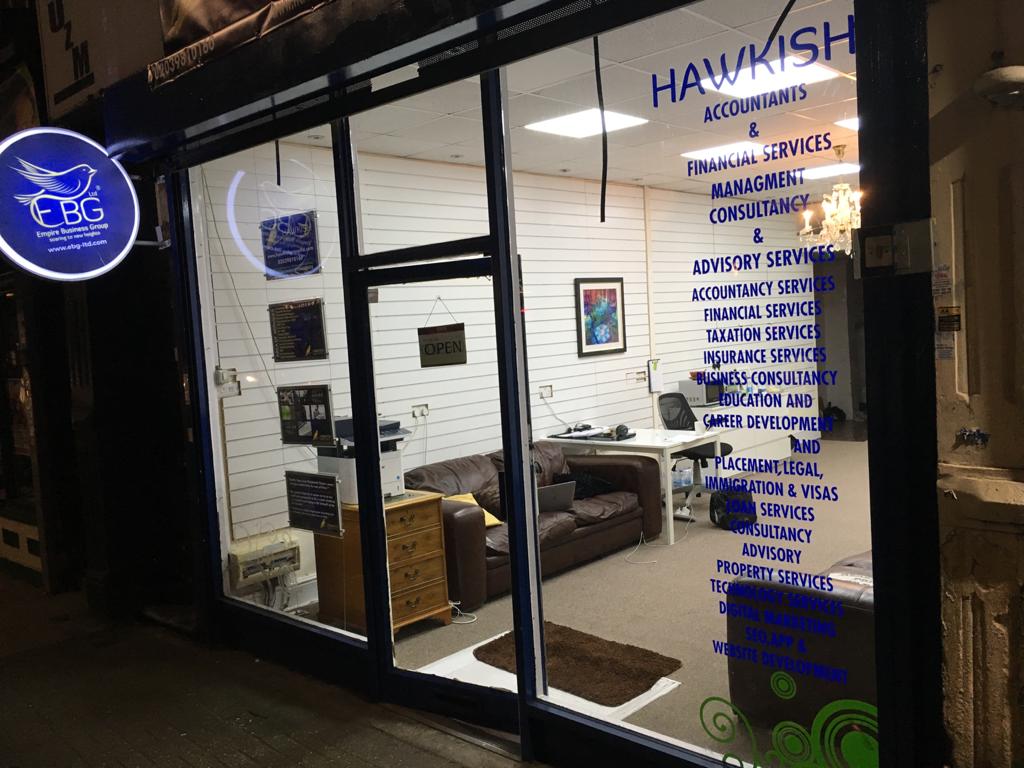 The first Hawkish office in Catford — storefront at night with HAWKISH accountants and financial services signage
